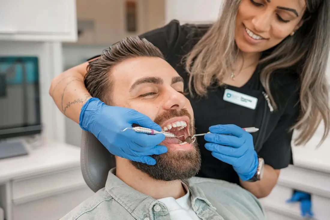 Smiling dental patient during a checkup at DentaVerge